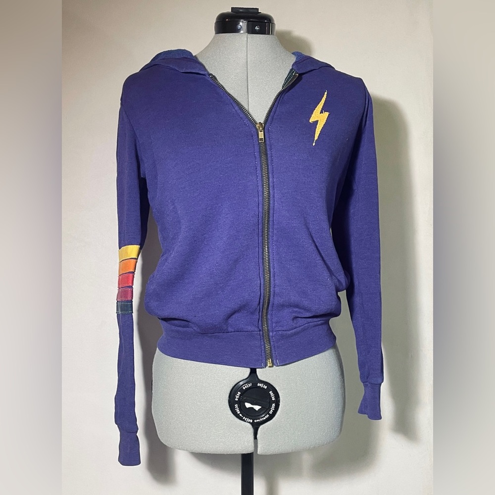 Purple Aviator Nation sweatshirt with a rainbow on the sleeve